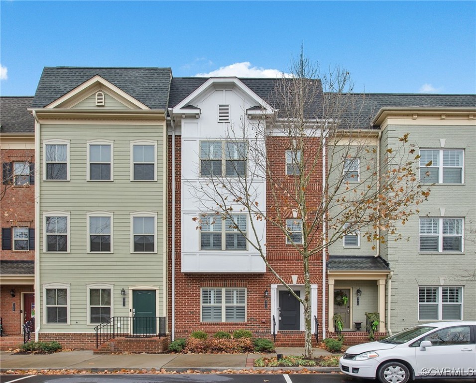 a front view of a residential apartment building with a yard