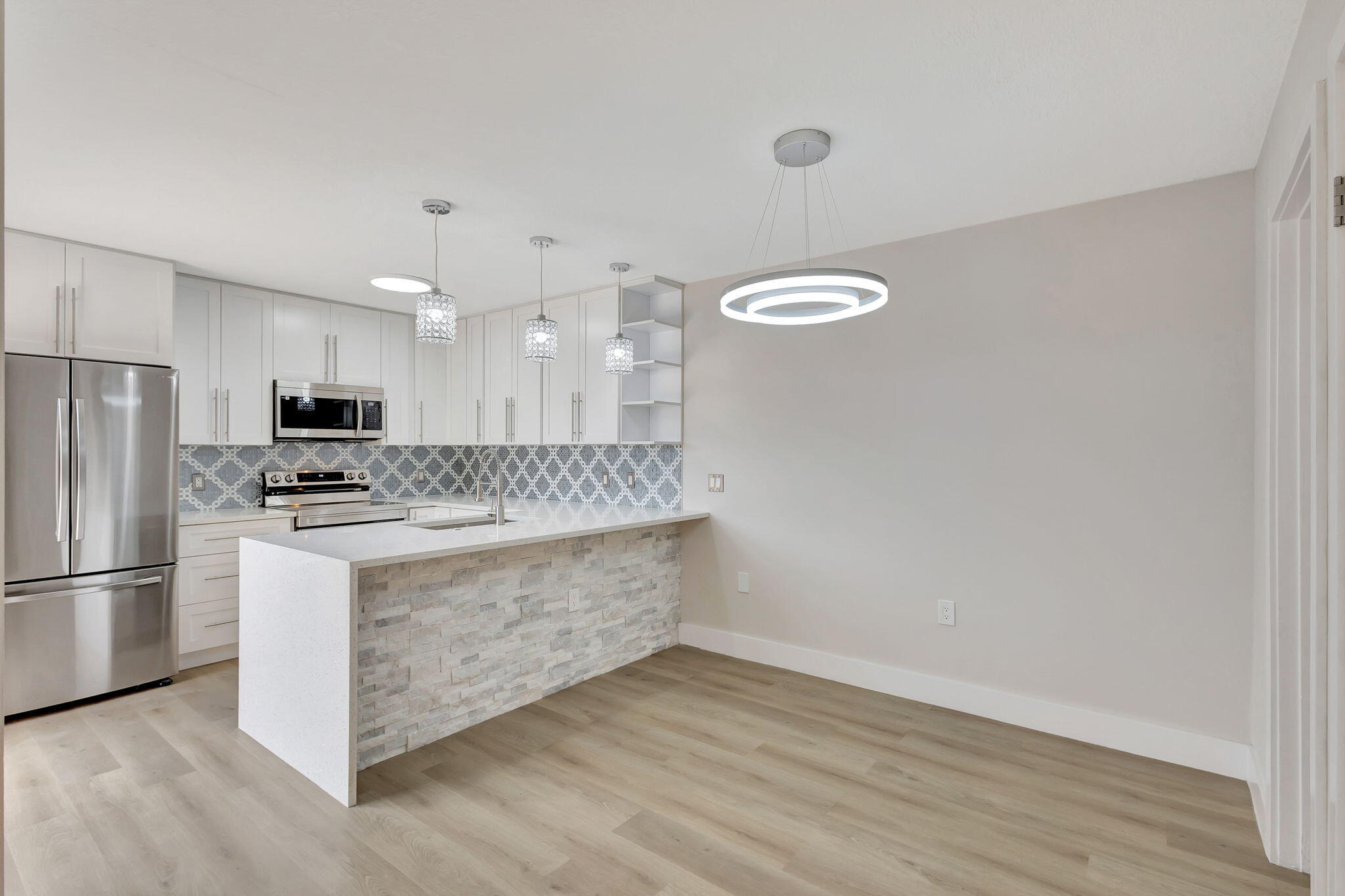 a view of kitchen with stainless steel appliances granite countertop cabinets and wooden floor