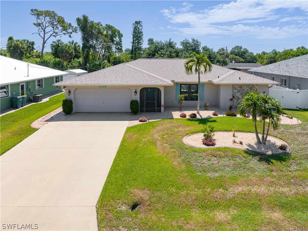 a front view of house with yard and green space