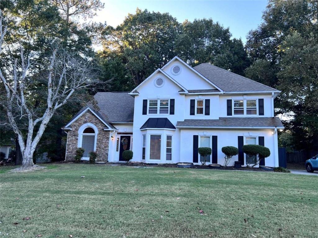 a front view of a house with a yard