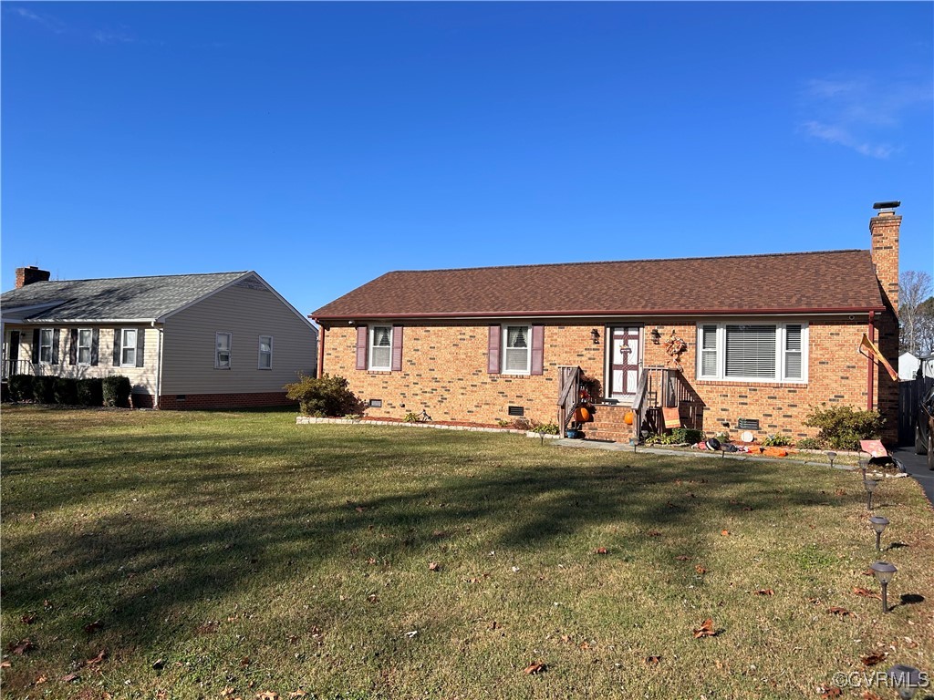 Ranch-style home with a front lawn