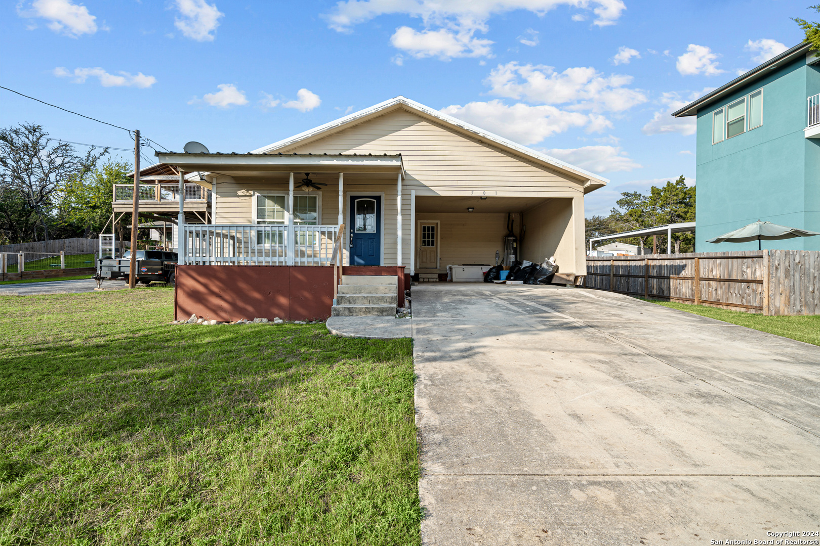 a front view of a house with a garden and patio