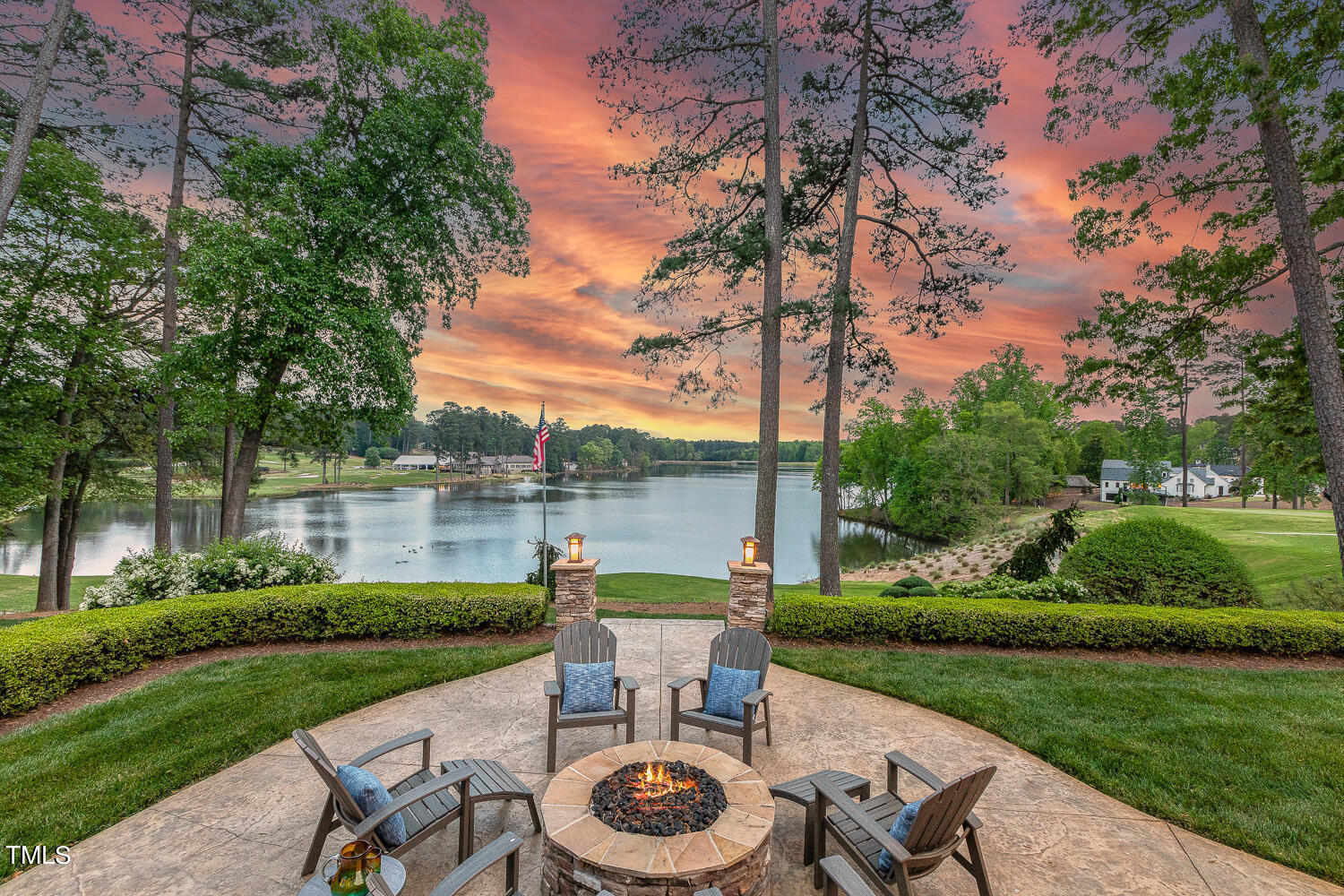 a view of a lake with a table and a chairs