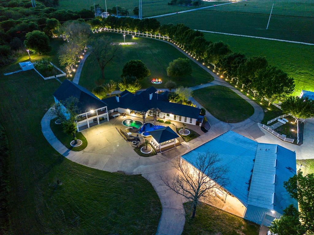 an aerial view of a house with yard swimming pool and outdoor seating