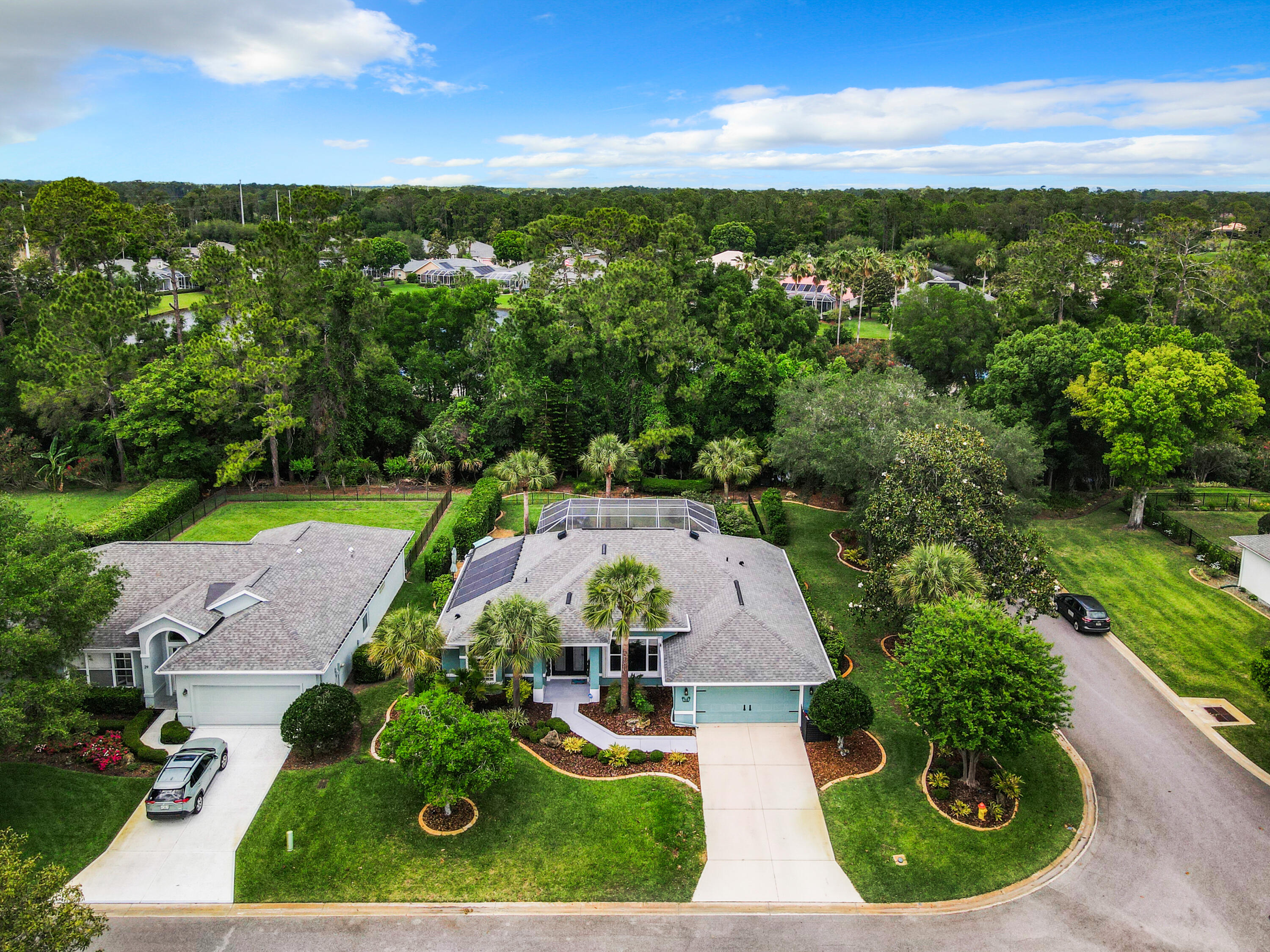 an aerial view of a house with garden space and ocean view