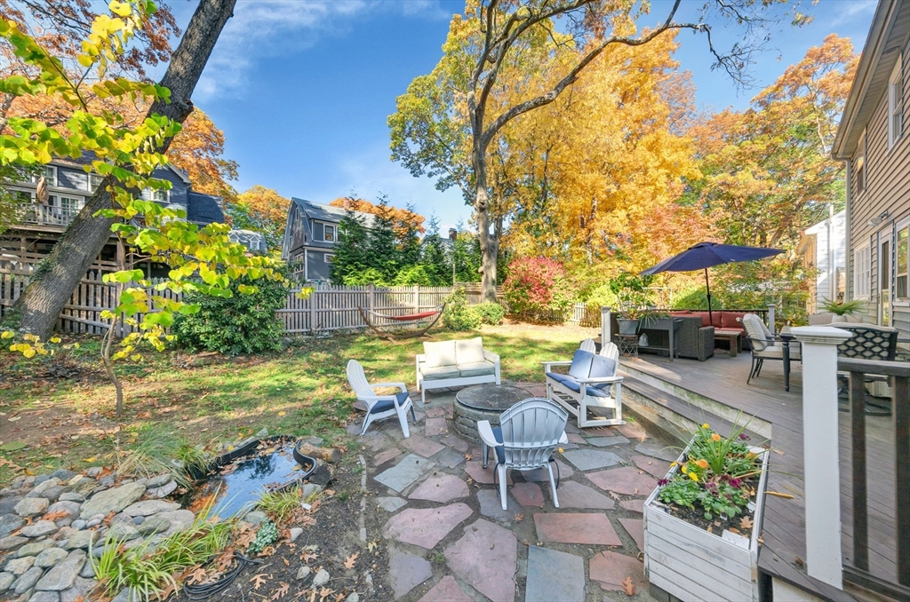 a view of swimming pool with outdoor seating and plants