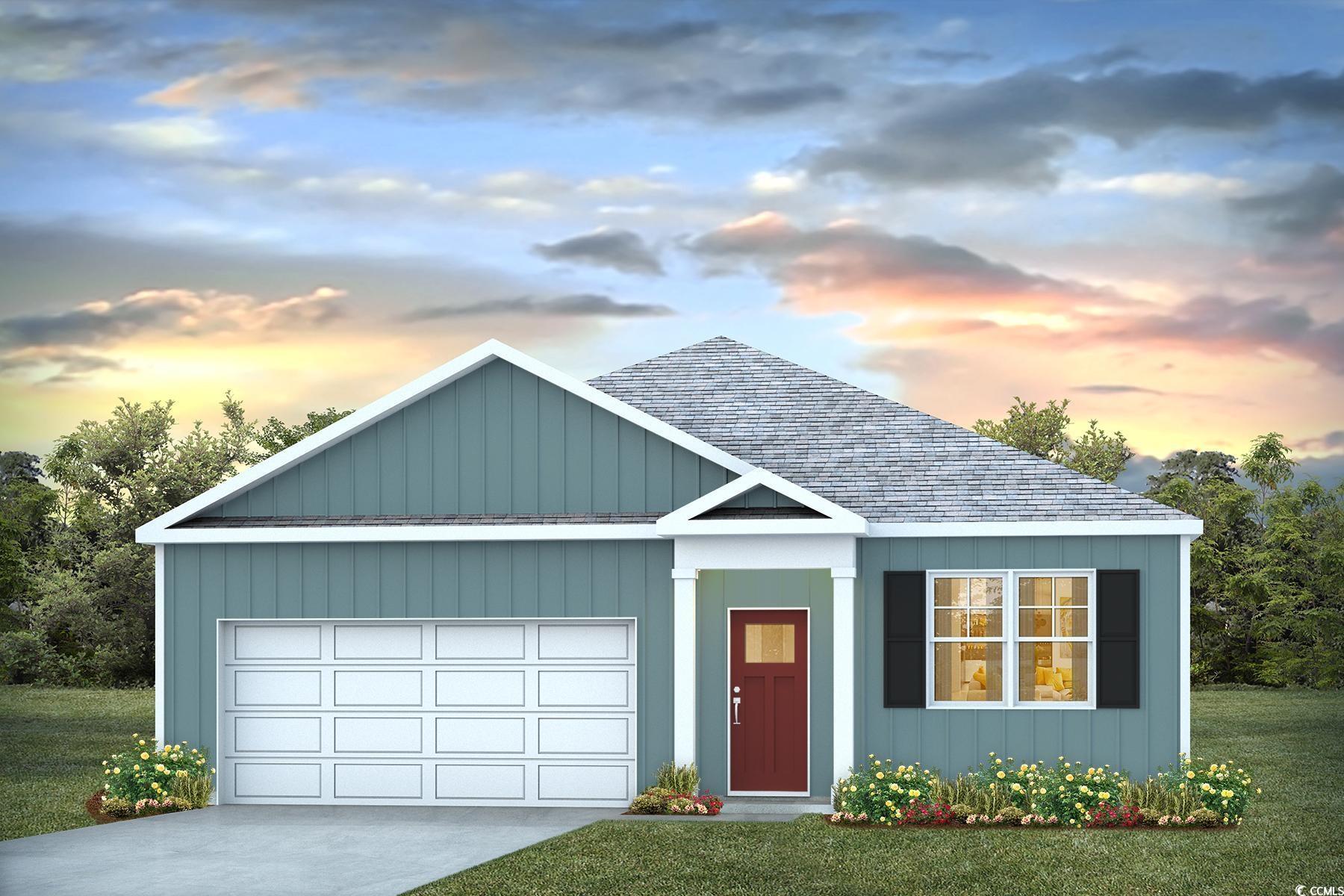 View of front of house with a yard and a garage