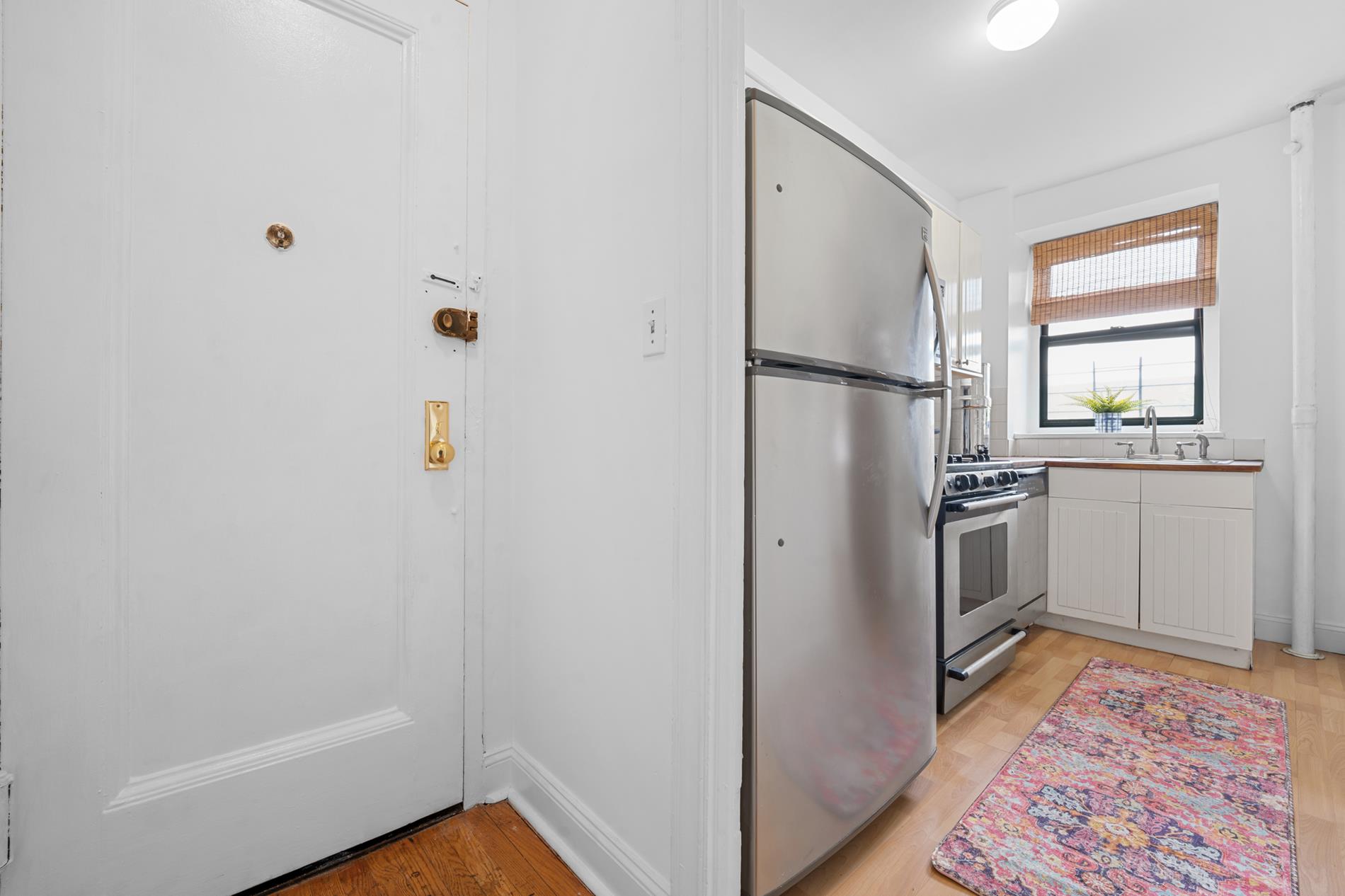 a kitchen with a refrigerator and a sink