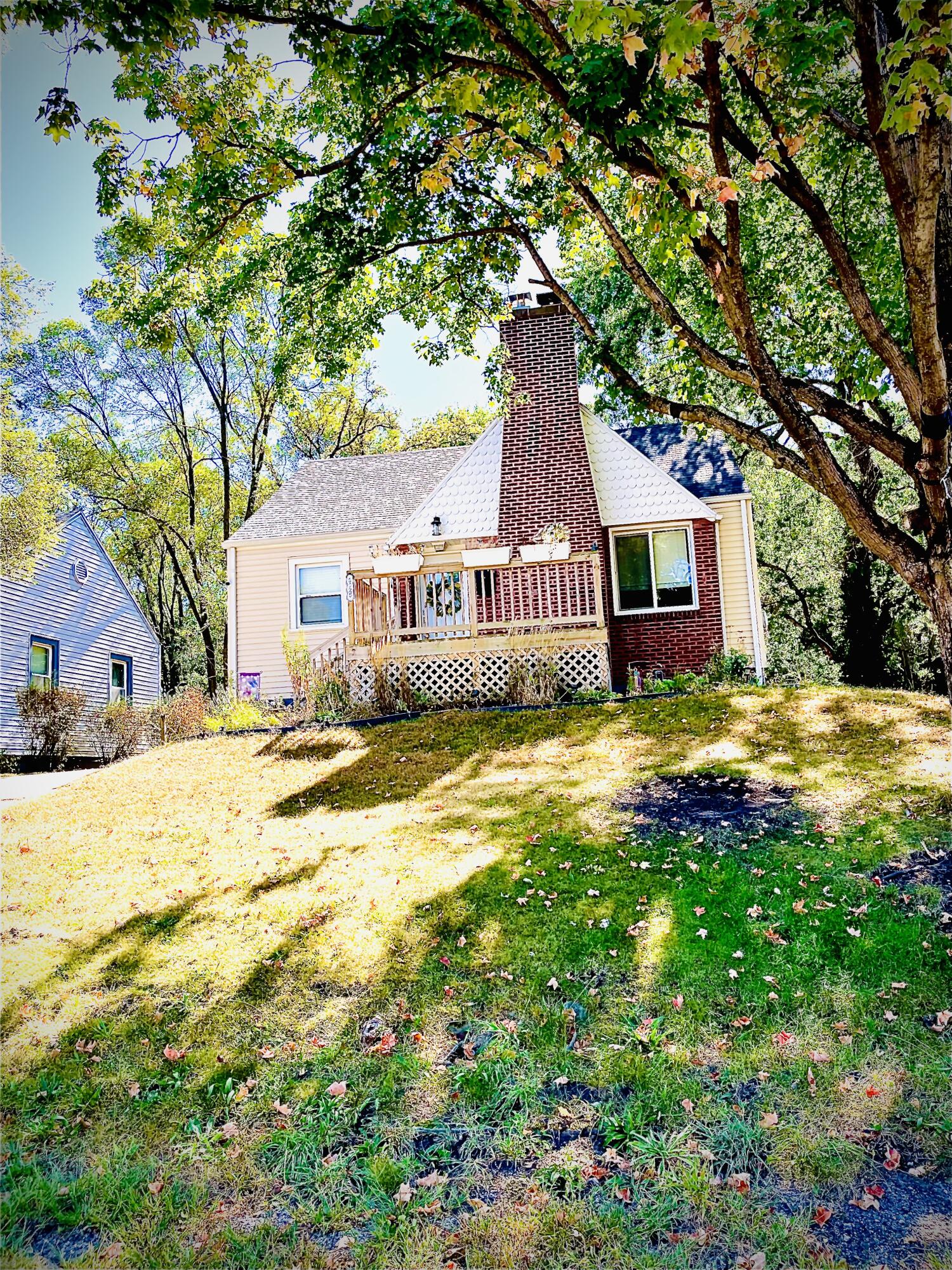 a front view of house with yard and swimming pool