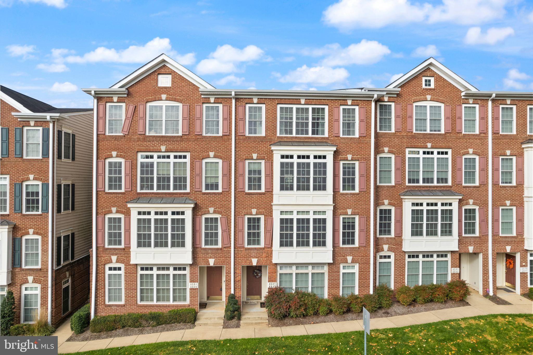 a front view of a residential apartment building with a yard