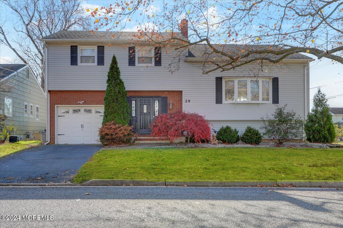 a front view of house with yard and green space