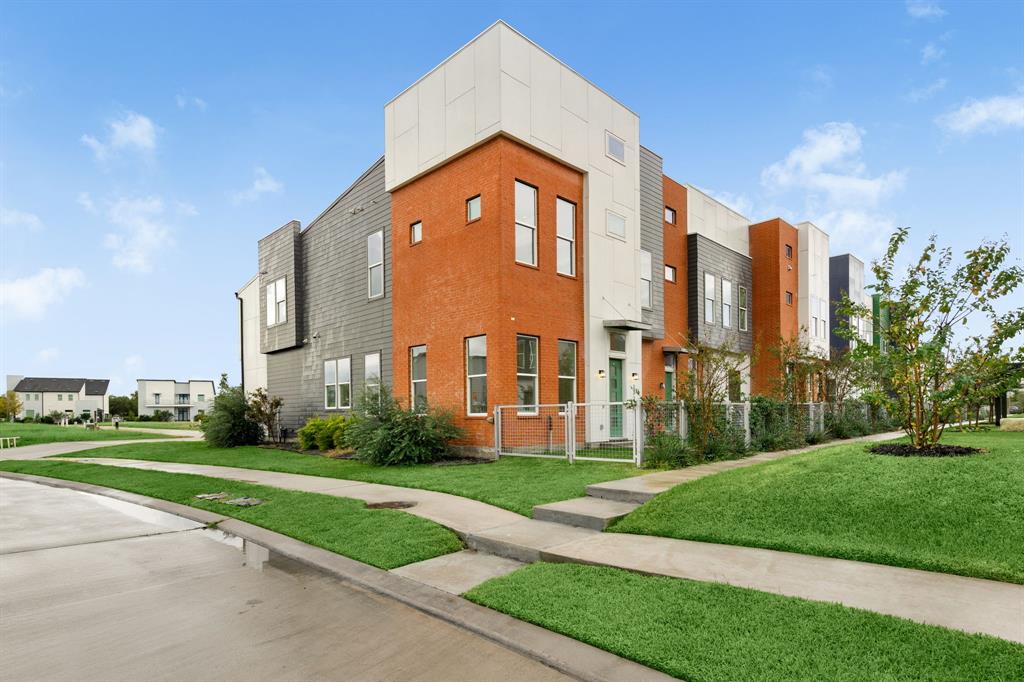 a front view of a building with a yard