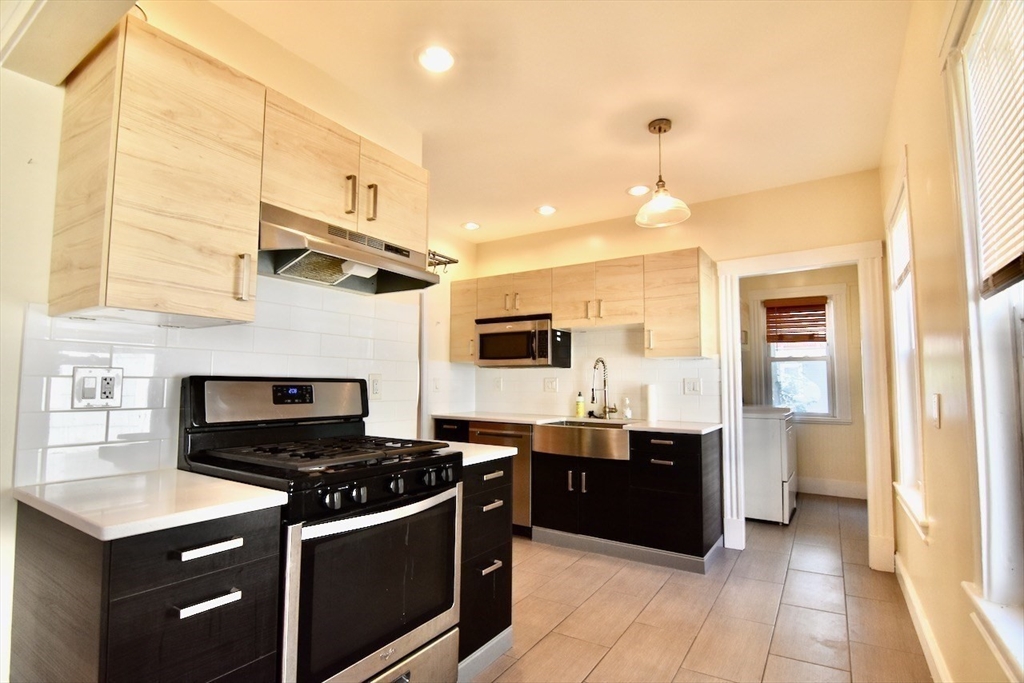 a kitchen with stainless steel appliances granite countertop a stove and a sink