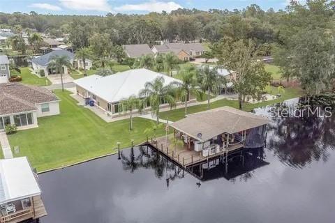 an aerial view of a house with pool table and chairs