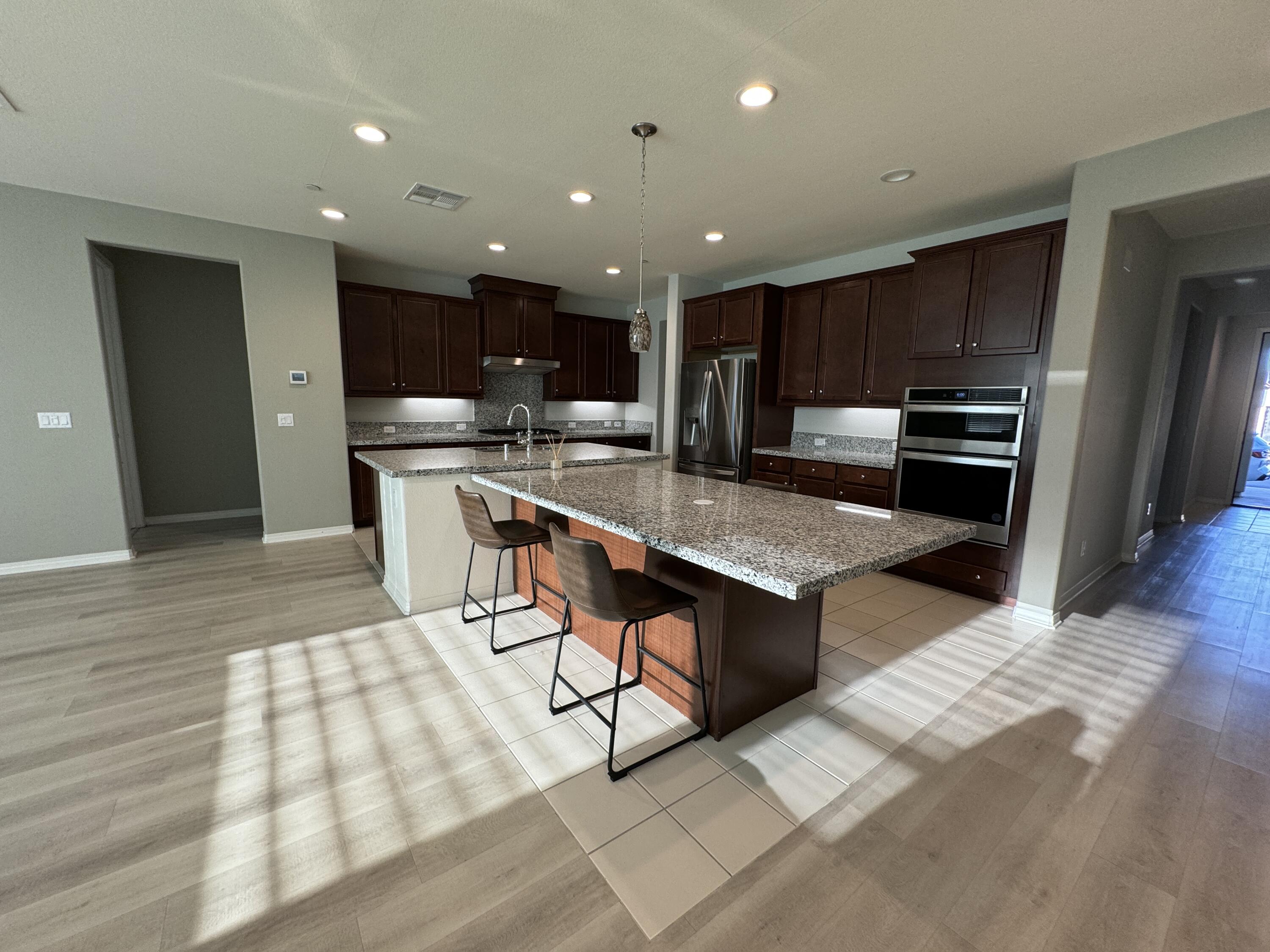 a kitchen with a sink stainless steel appliances and counter space