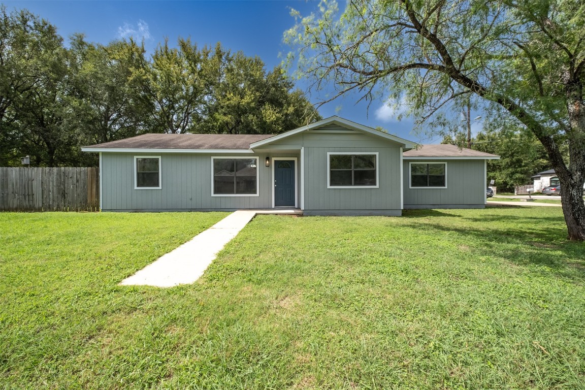 a front view of house with yard and green space