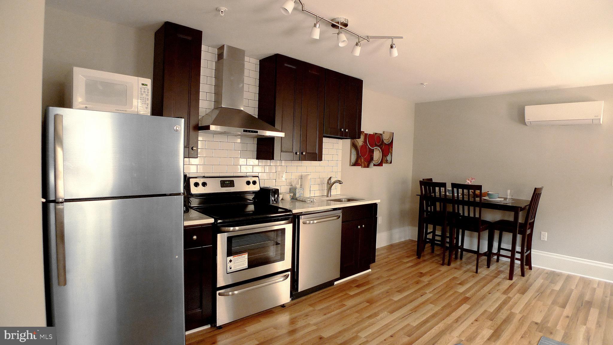 a kitchen with stainless steel appliances a refrigerator stove and sink