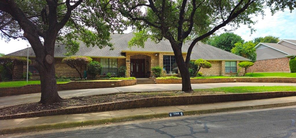 a house with tree in front of it