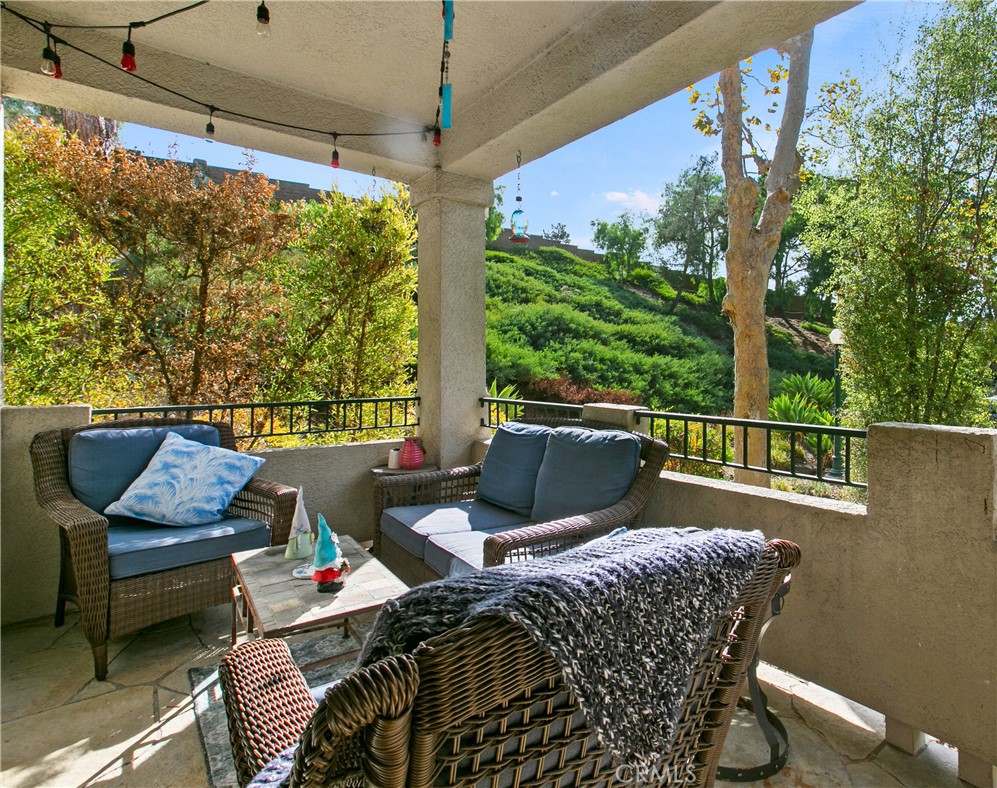 a balcony with furniture and a potted plant