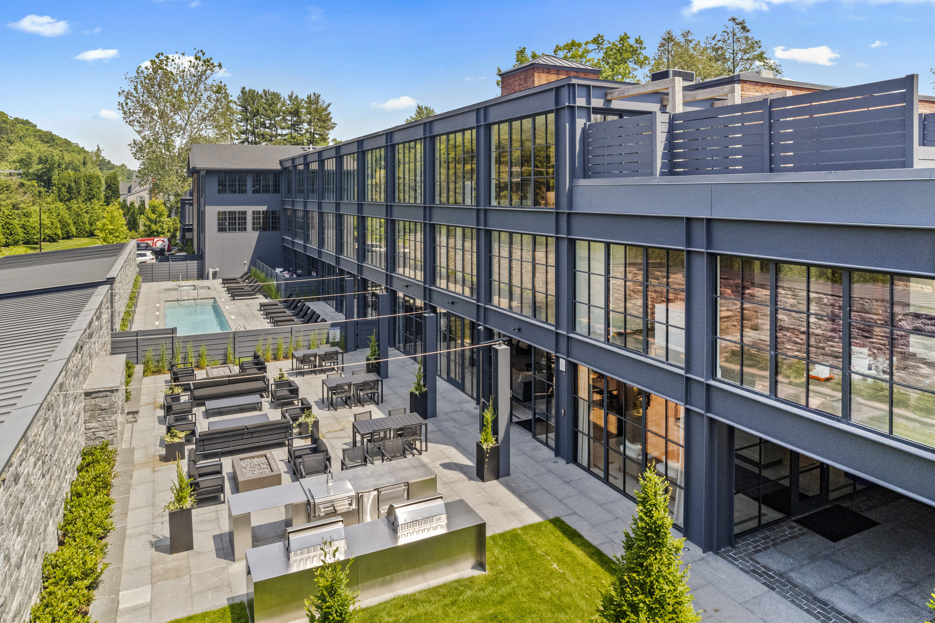 a view of a house with pool and chairs