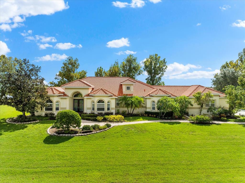 a front view of house with yard and green space