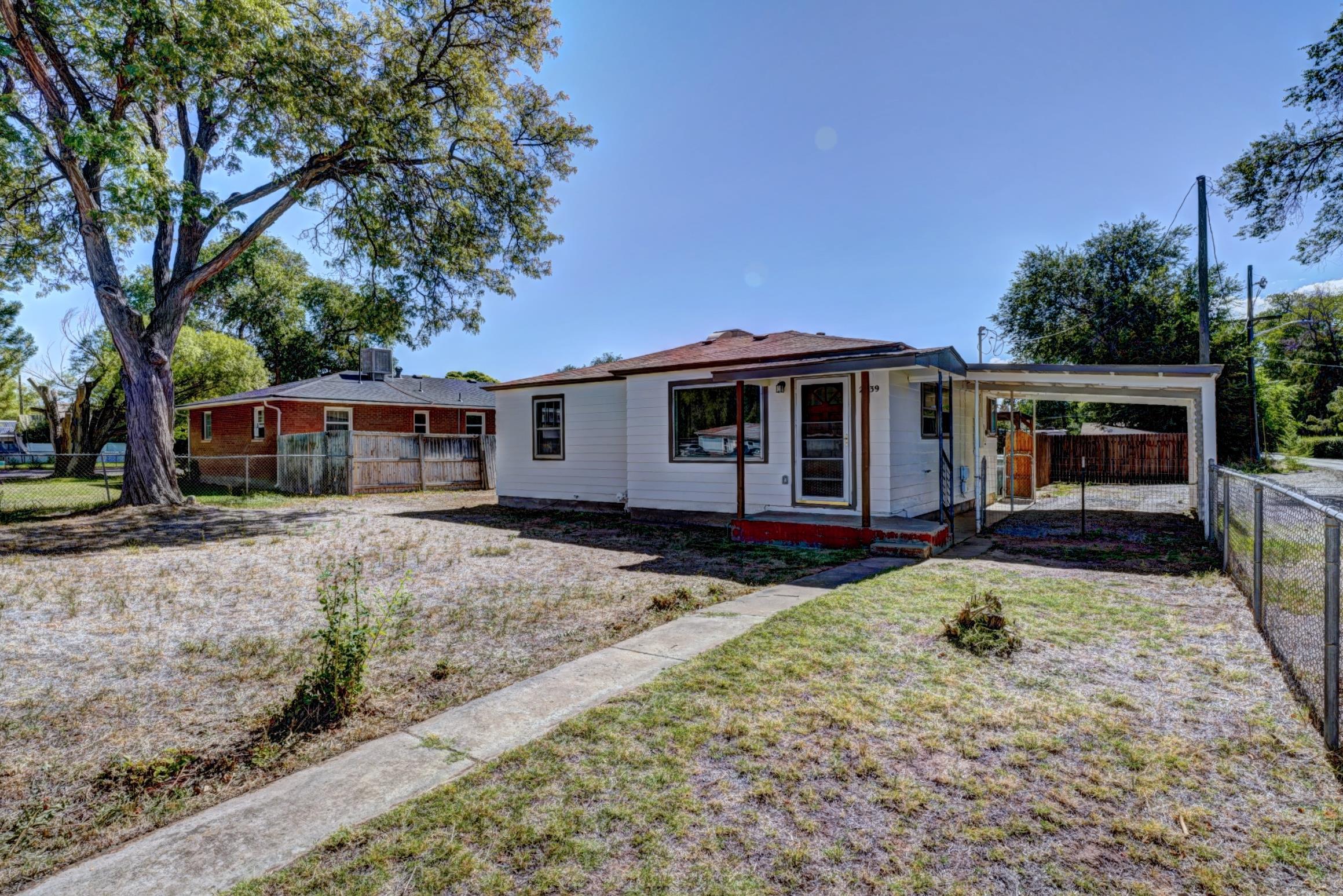 a view of a house with backyard sitting area and porch