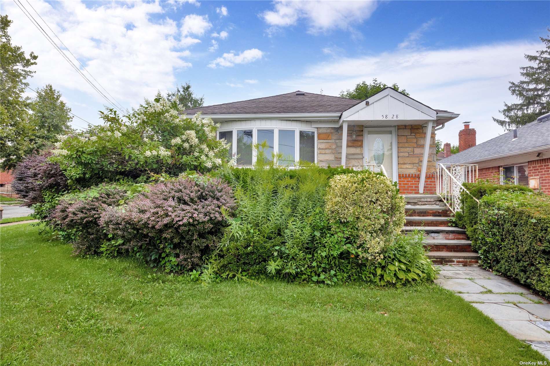 a front view of a house with a garden