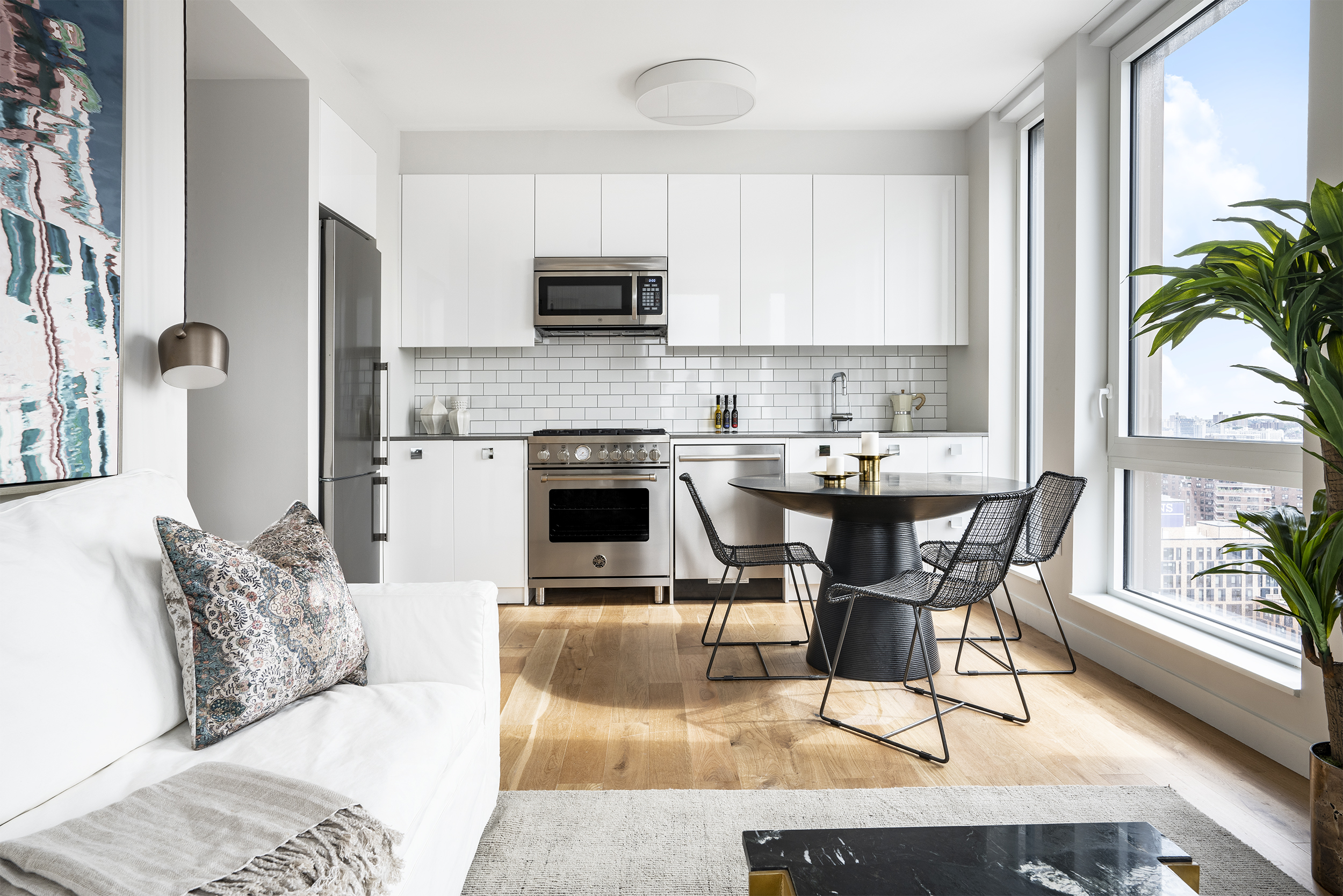 a living room with stainless steel appliances kitchen island granite countertop furniture and a fireplace