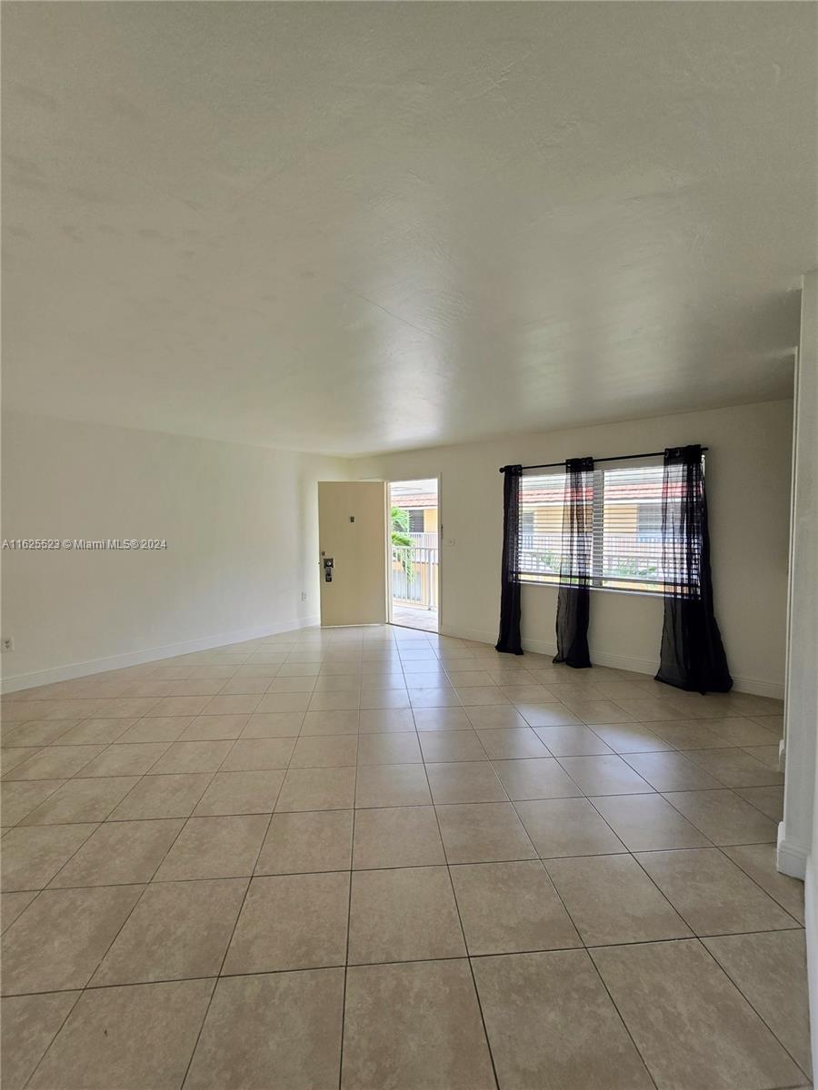 a view of empty room with a fireplace