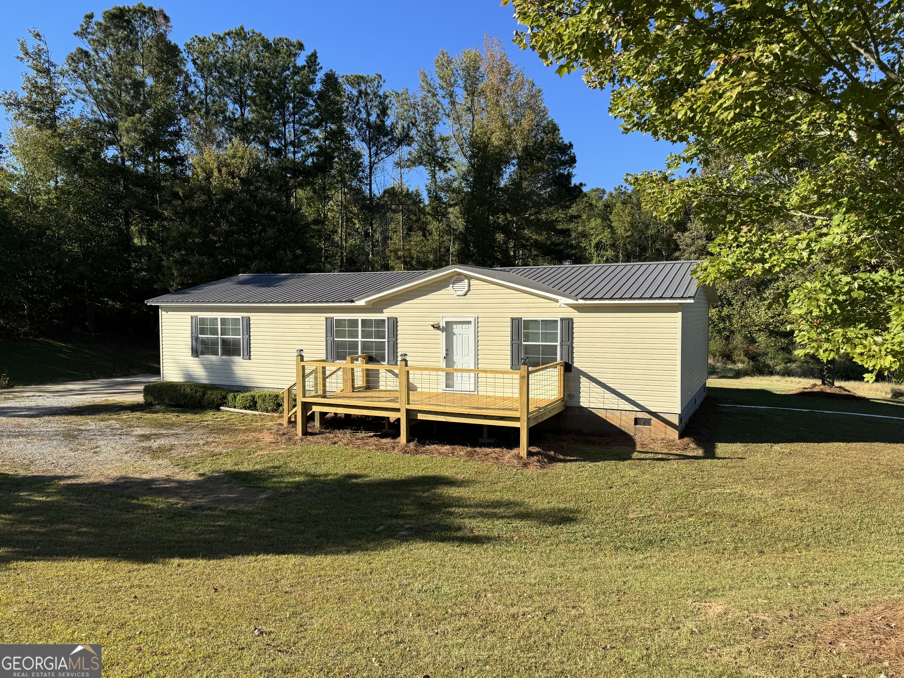 a front view of house with yard and lake