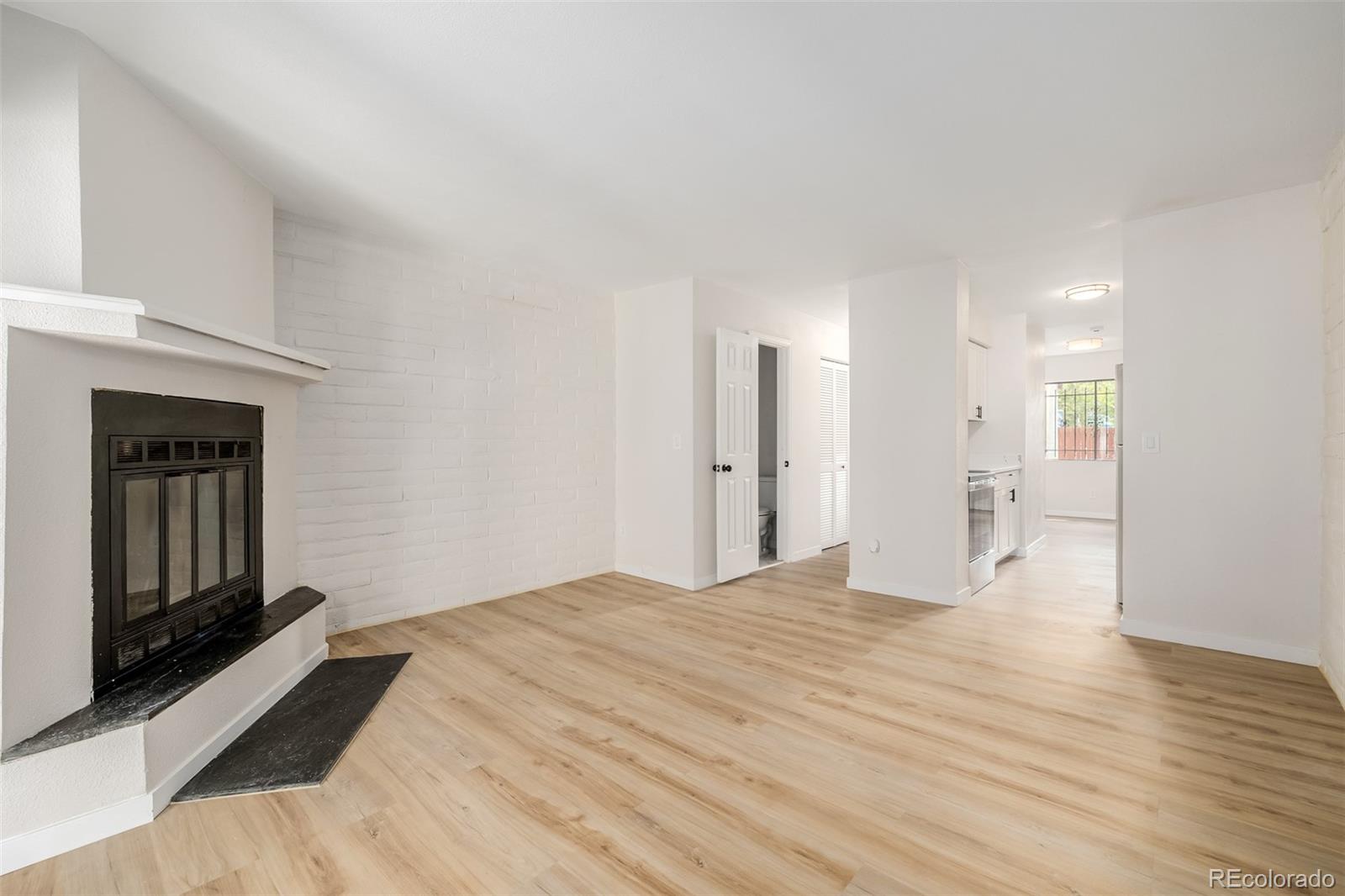 a big room with wooden floor and windows