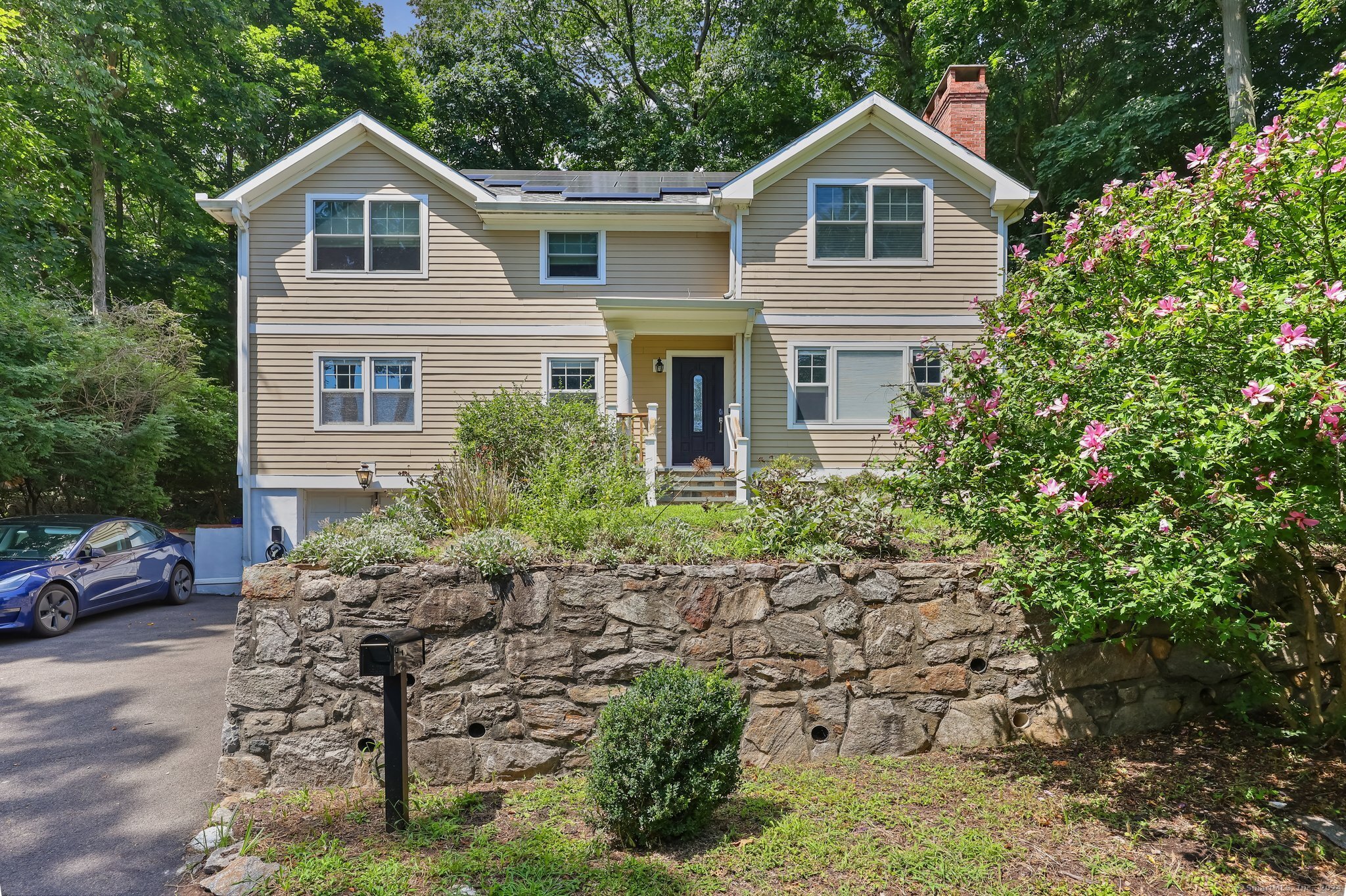 a front view of a house with garden