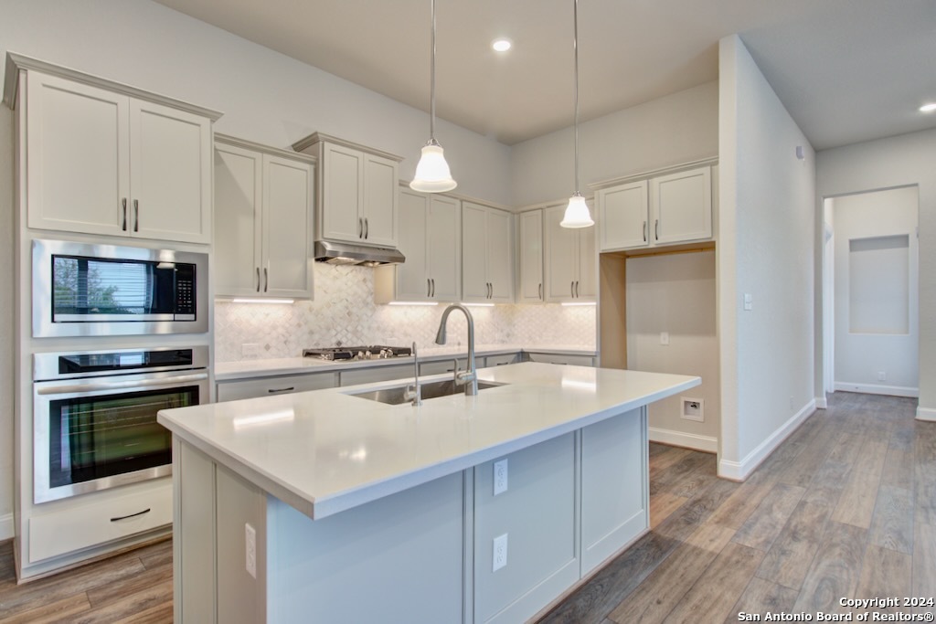 a kitchen with a stove a sink and a refrigerator