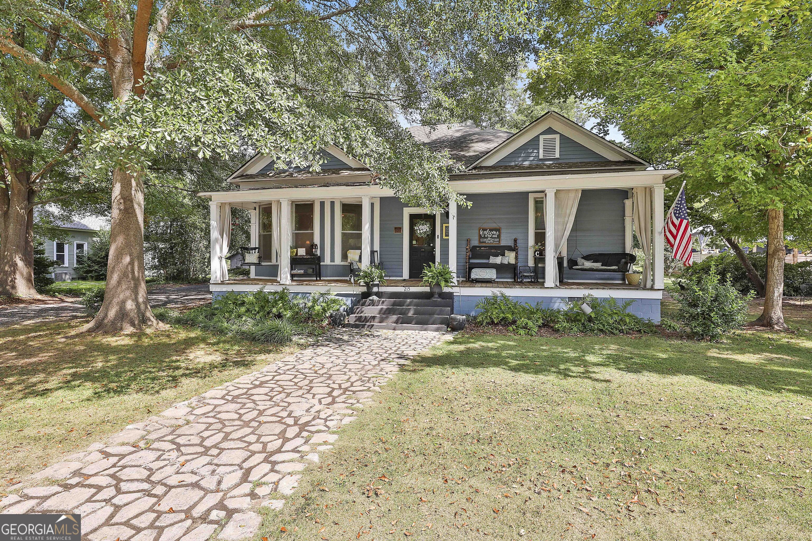 a front view of a house with garden