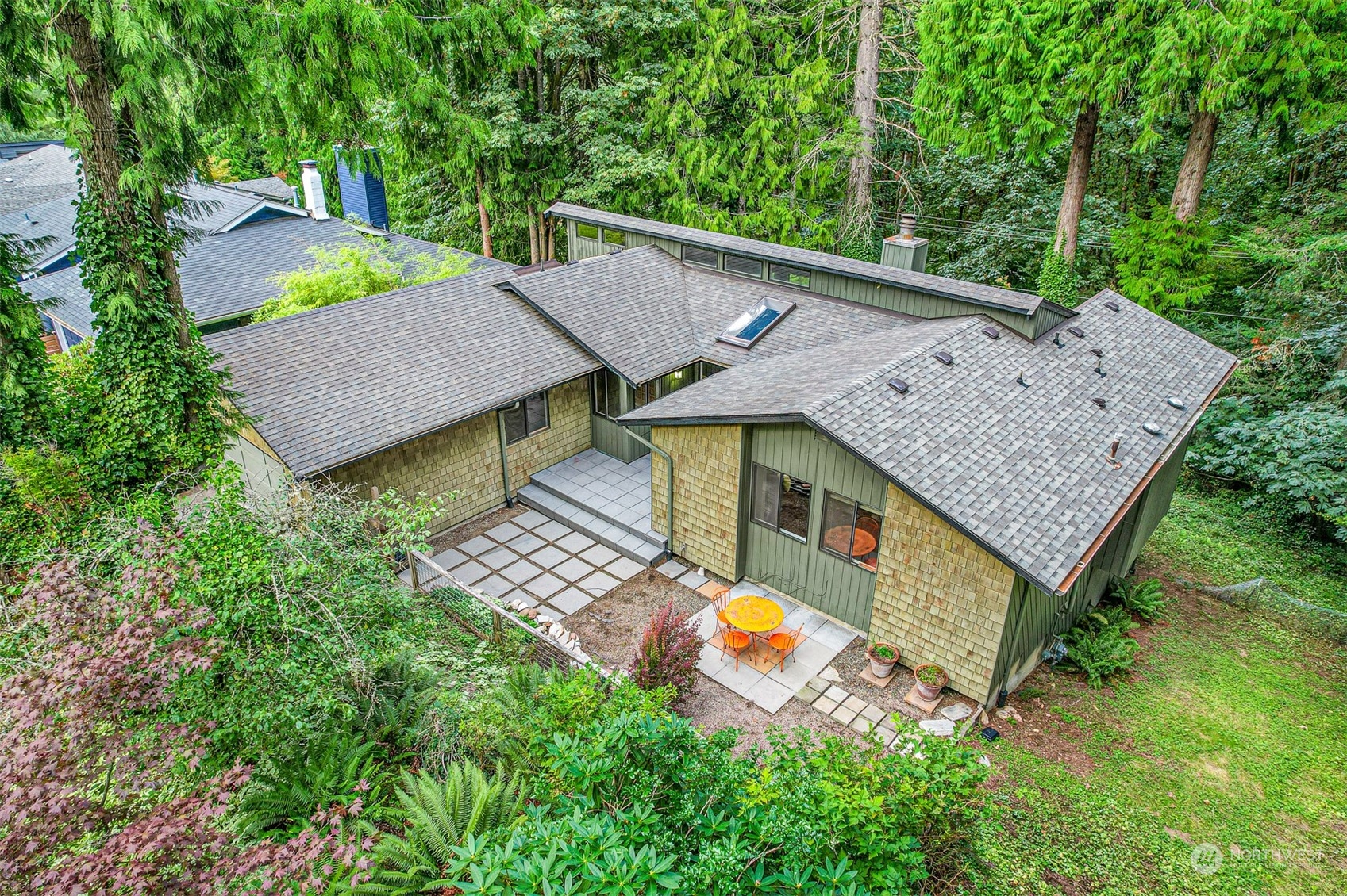 an aerial view of a house with swimming pool and patio