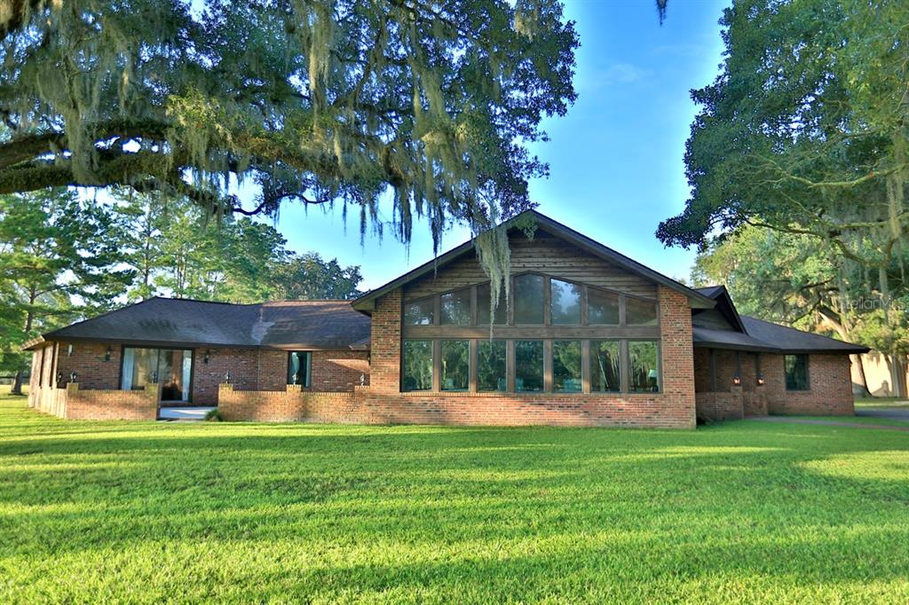 a front view of a house with a yard porch and green space