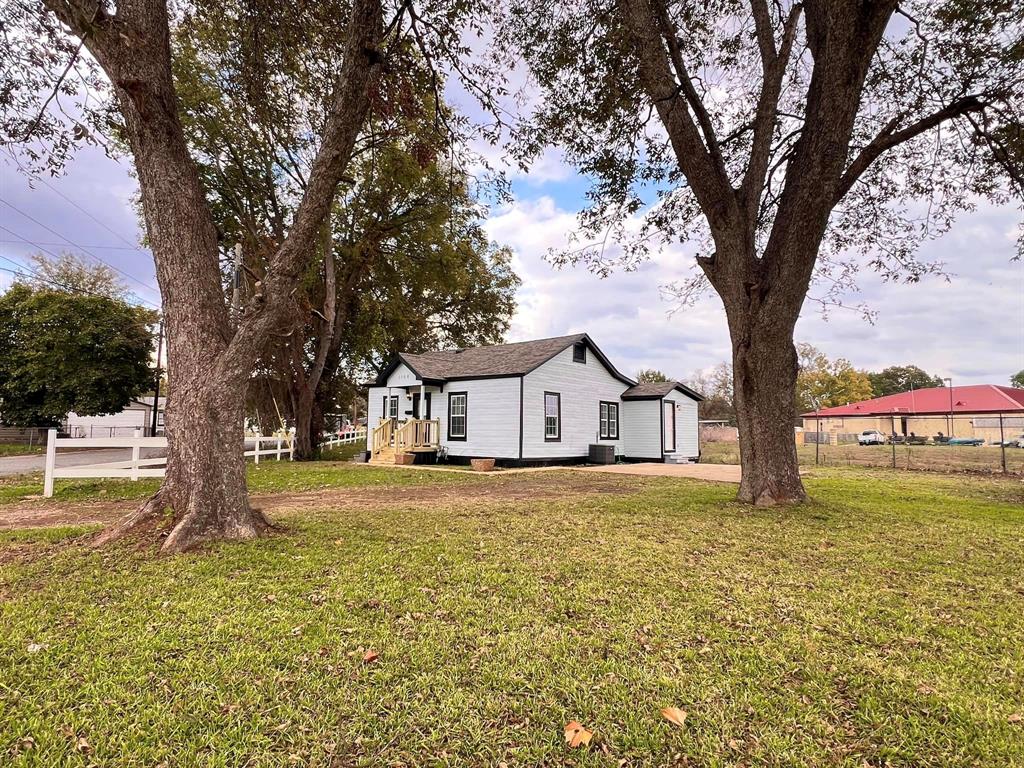 a big house with trees in front of it