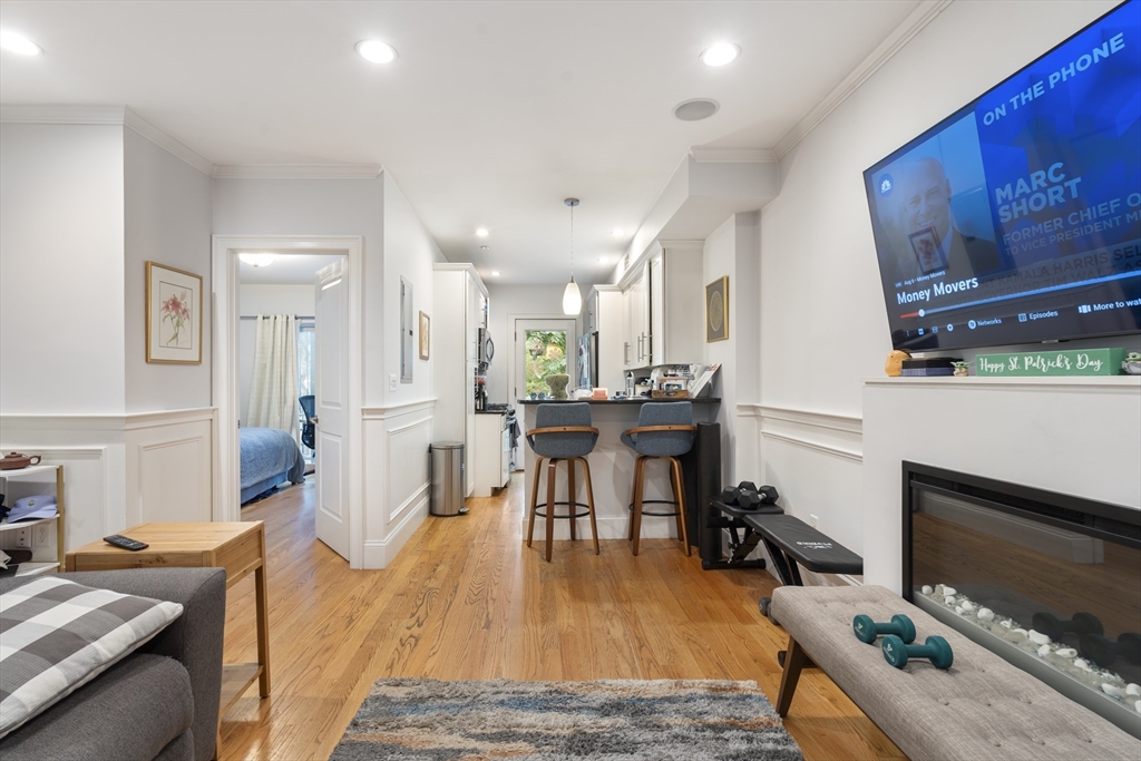 a living room with furniture appliances and a flat screen tv