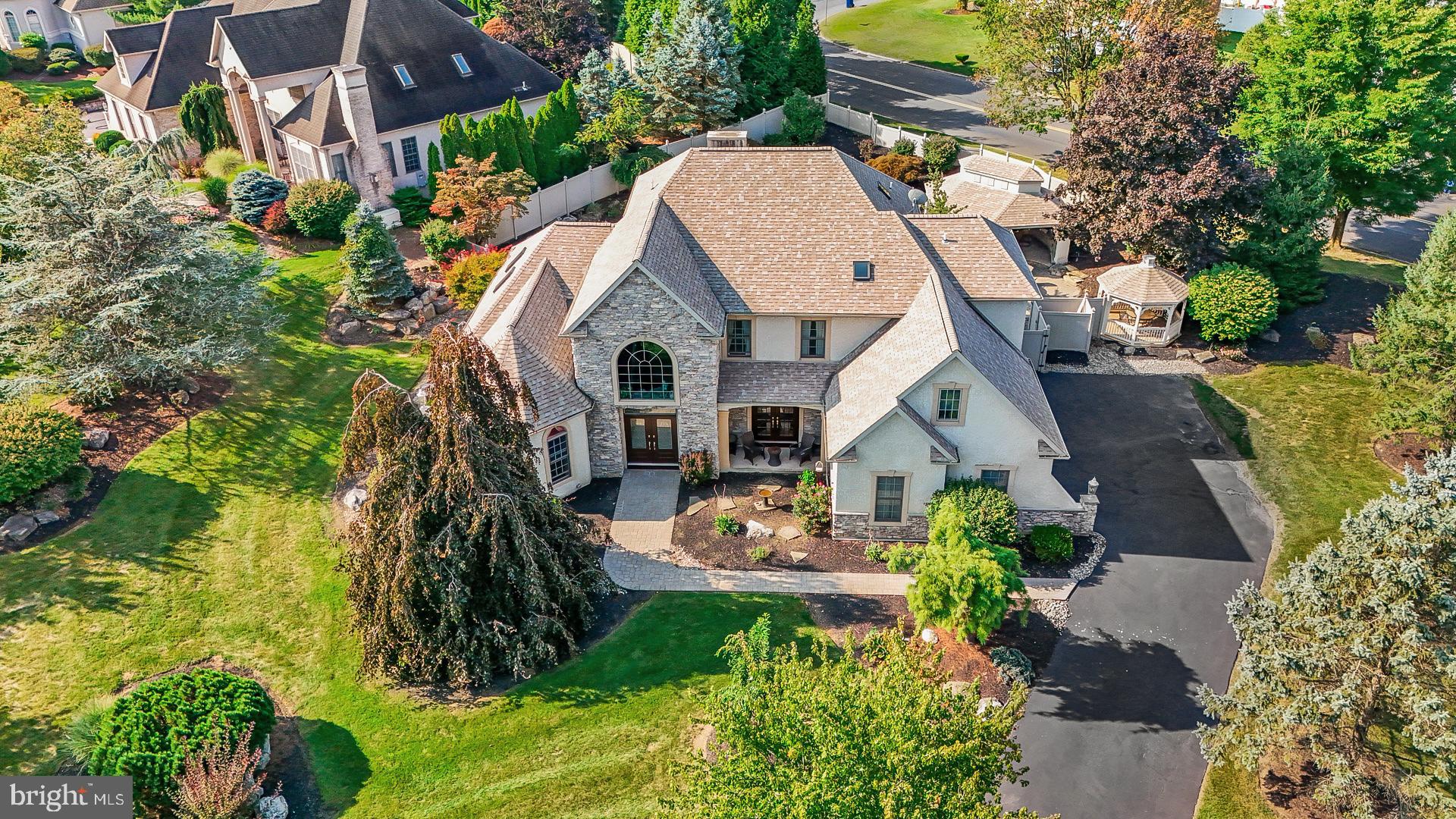 an aerial view of a house with swimming pool and garden