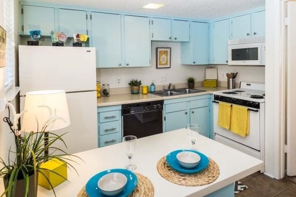 a kitchen with a sink a stove and refrigerator