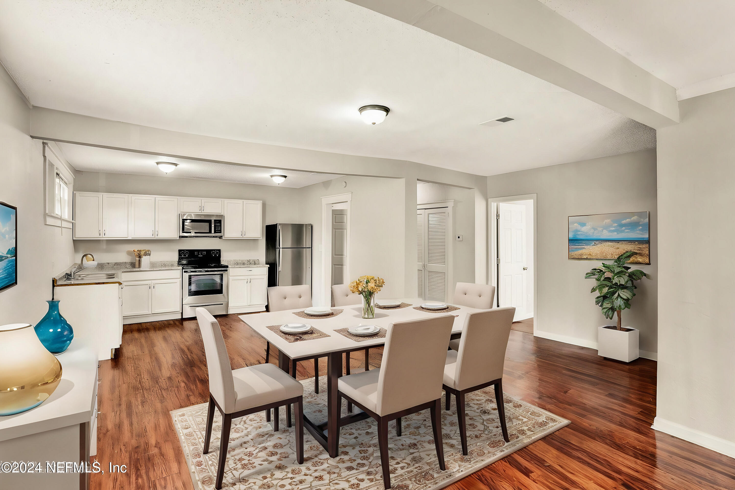 a dining room with furniture and wooden floor