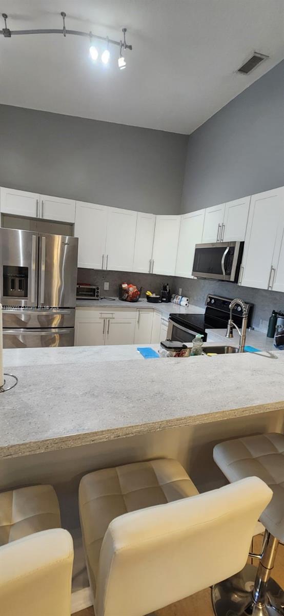 a kitchen with a stove a sink and a refrigerator