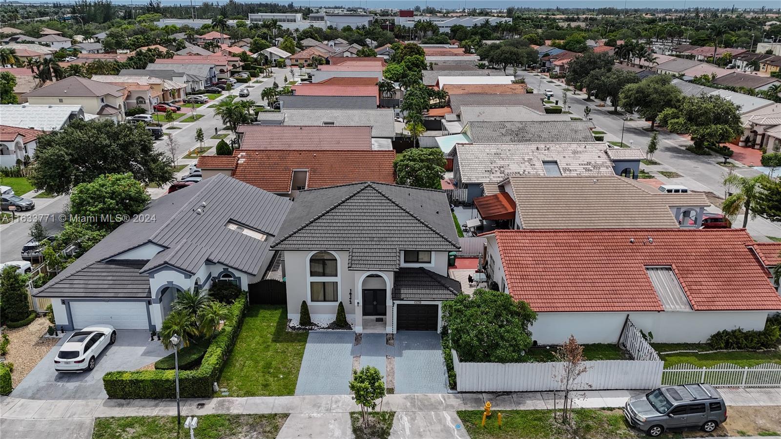 an aerial view of multiple houses with a yard