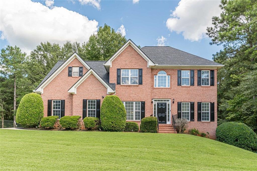 a front view of a house with a yard