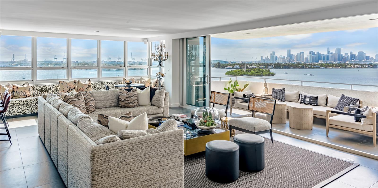 a living room with furniture and a floor to ceiling window