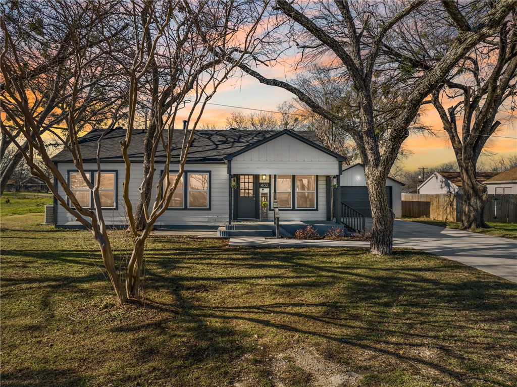 a view of a house with trees in the background