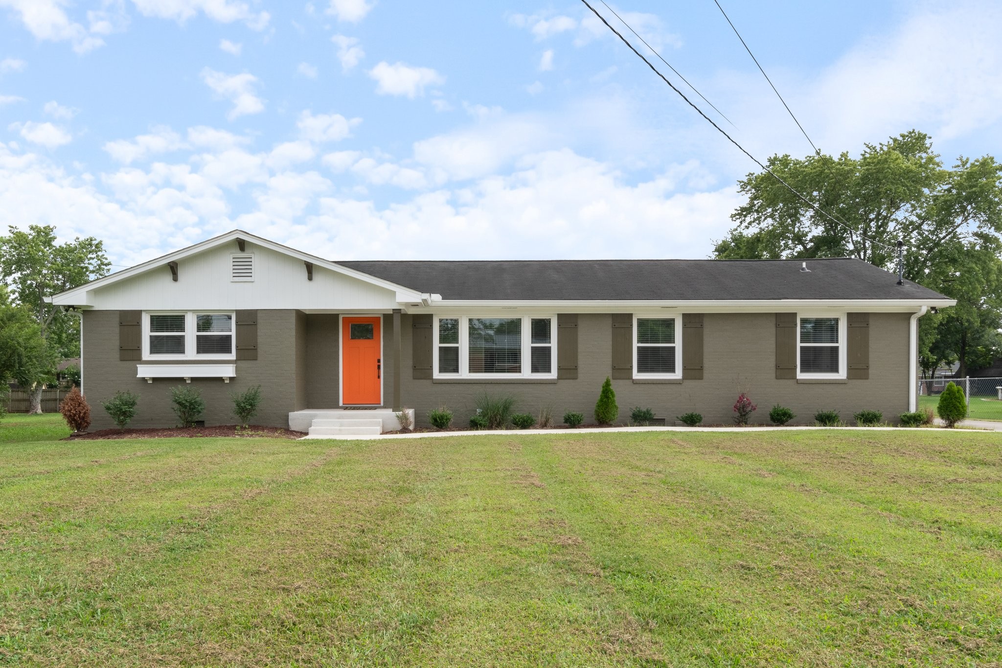 a front view of house with yard and green space