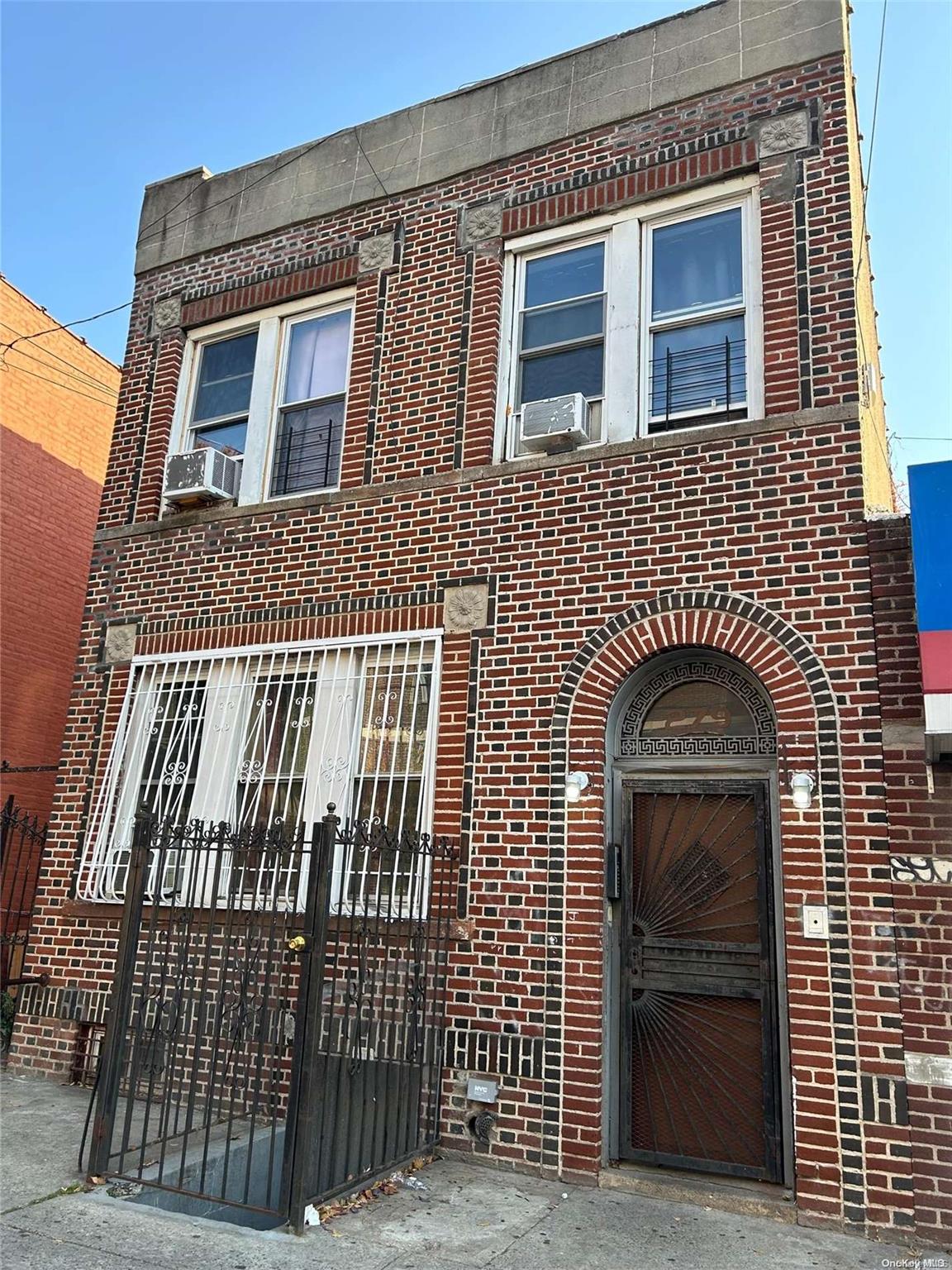 a view of a brick house with many windows