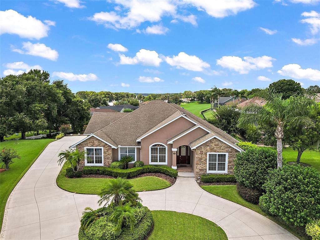 Welcoming you home is a circular drive and side entry garage