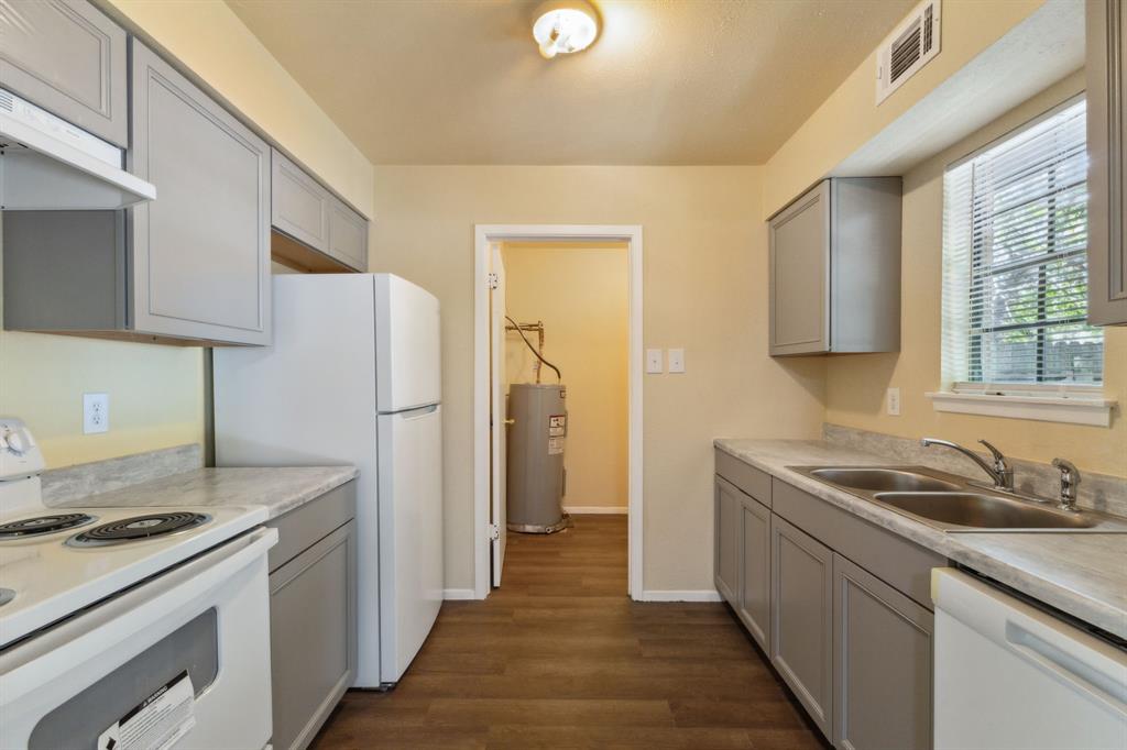 a kitchen with a sink stove and refrigerator